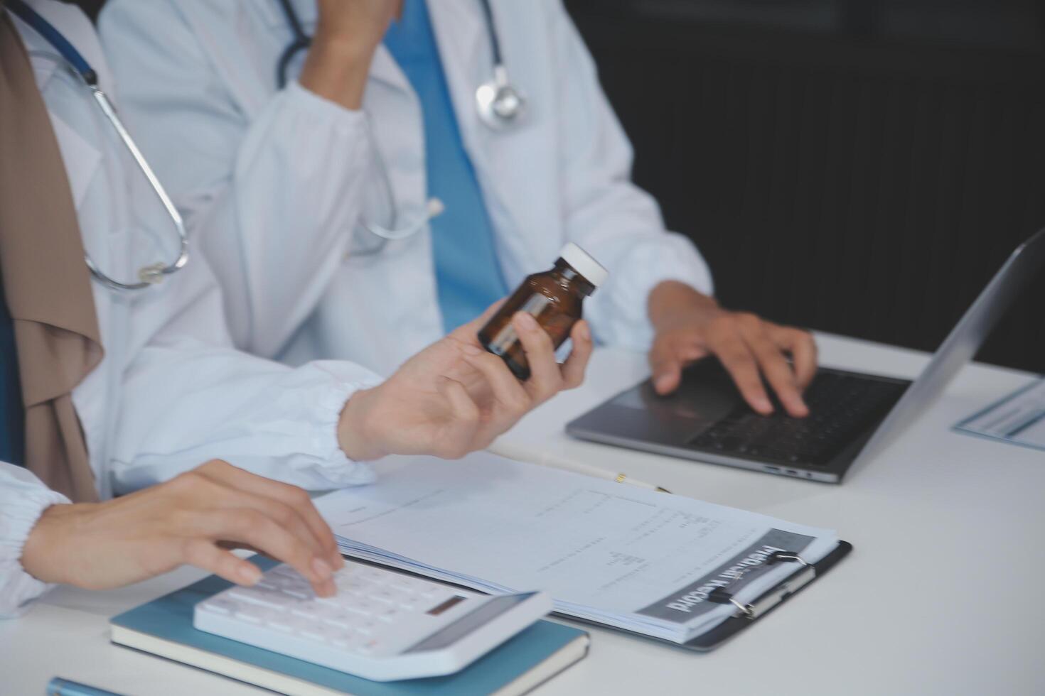 ásia psicólogo mulheres apontando em pílulas garrafa para explicando remédio e prescrição para fêmea paciente enquanto dando aconselhamento sobre médico e mental saúde terapia para fêmea paciente dentro clínica. foto