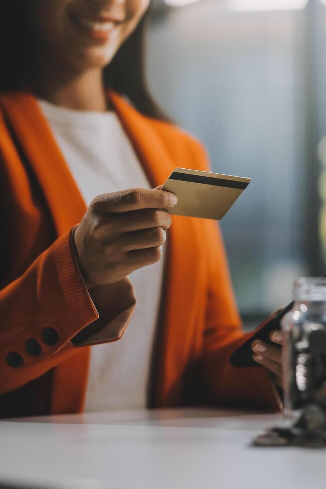 mulher é fazendo conectados compras. menina é fazendo compras usando telefone e crédito cartão às lar. foto