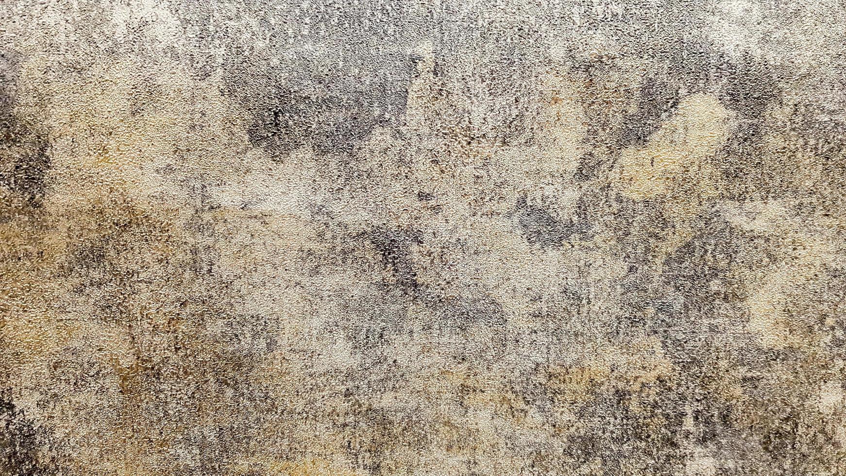 textura de gesso de parede de concreto sujo marrom, cinza e dourado. pintura decorativa para paredes ou fundo de estilo grunge. gesso decorativo. foto