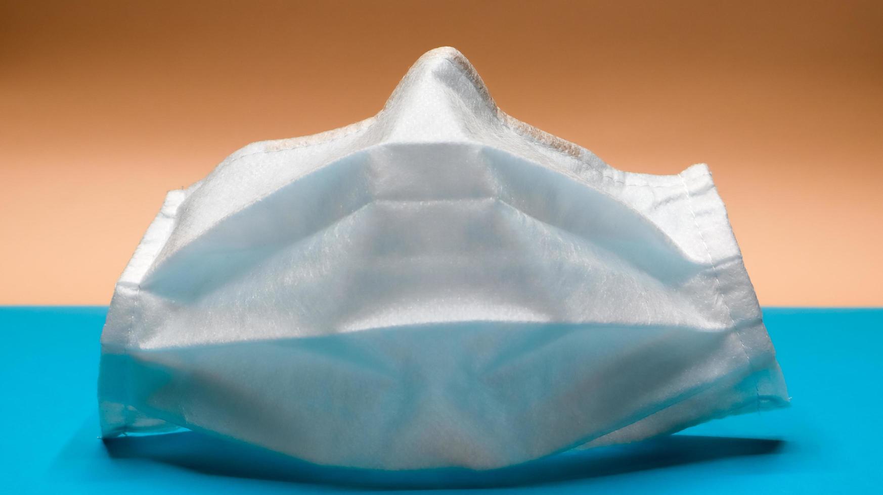 uma máscara facial cirúrgica descartável de 3 camadas com almofadas de borracha para cobrir a boca e o nariz. o conceito de proteção contra bactérias, saúde e medicamentos. covid19. vírus perigoso foto