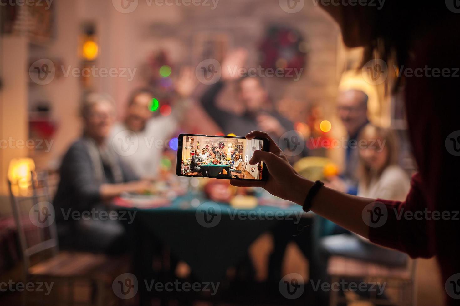 garota usando smartphone para tirar fotos de sua família