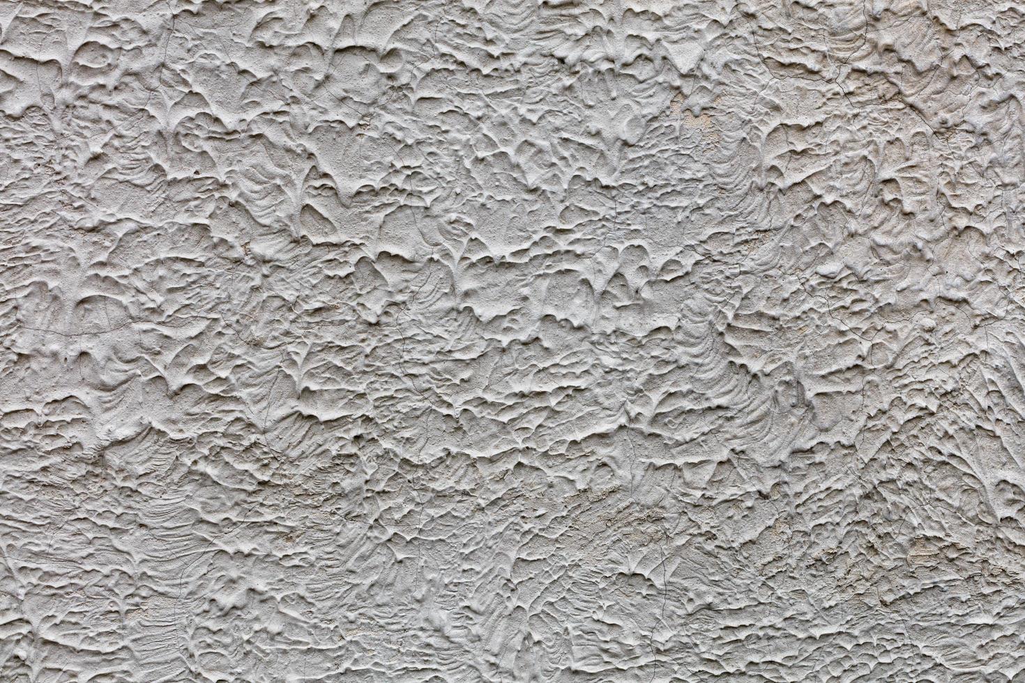 uma parede texturizada cinza coberta com uma mistura de concreto líquido congelado, plano de fundo e textura, close-up. foto