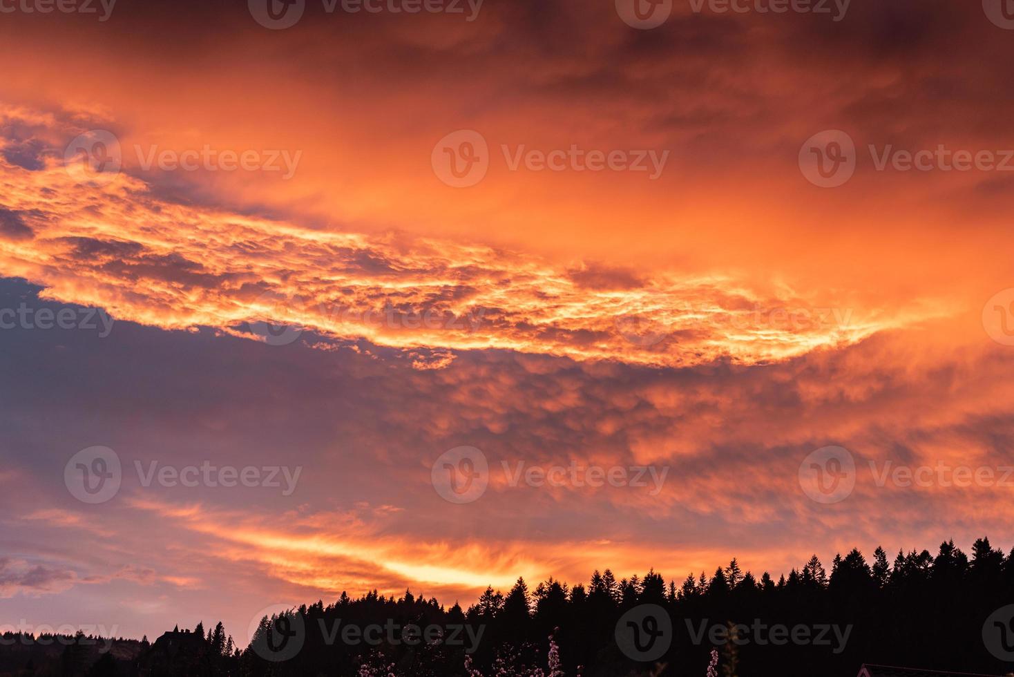 lindo pôr do sol de verão com céu laranja e nuvens foto