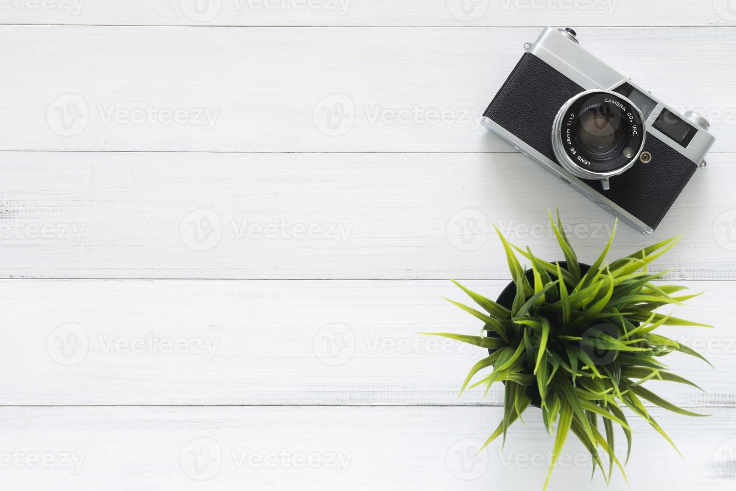 espaço de trabalho mínimo - foto criativa plana da mesa do espaço de trabalho. mesa de escritório mesa de madeira com câmera velha. vista superior com espaço de cópia. vista superior da câmera velha sobre a mesa de madeira. filtro retro vintage.