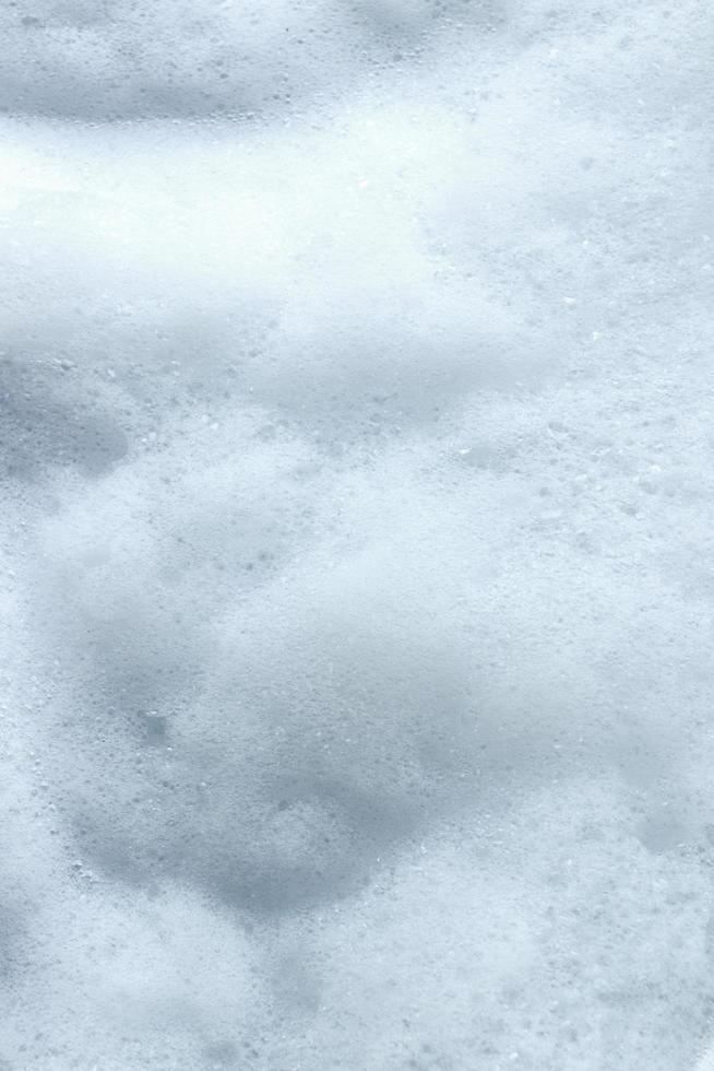 bolha de espuma branca de fundo de textura de lavagem de sabão ou shampoo. foto