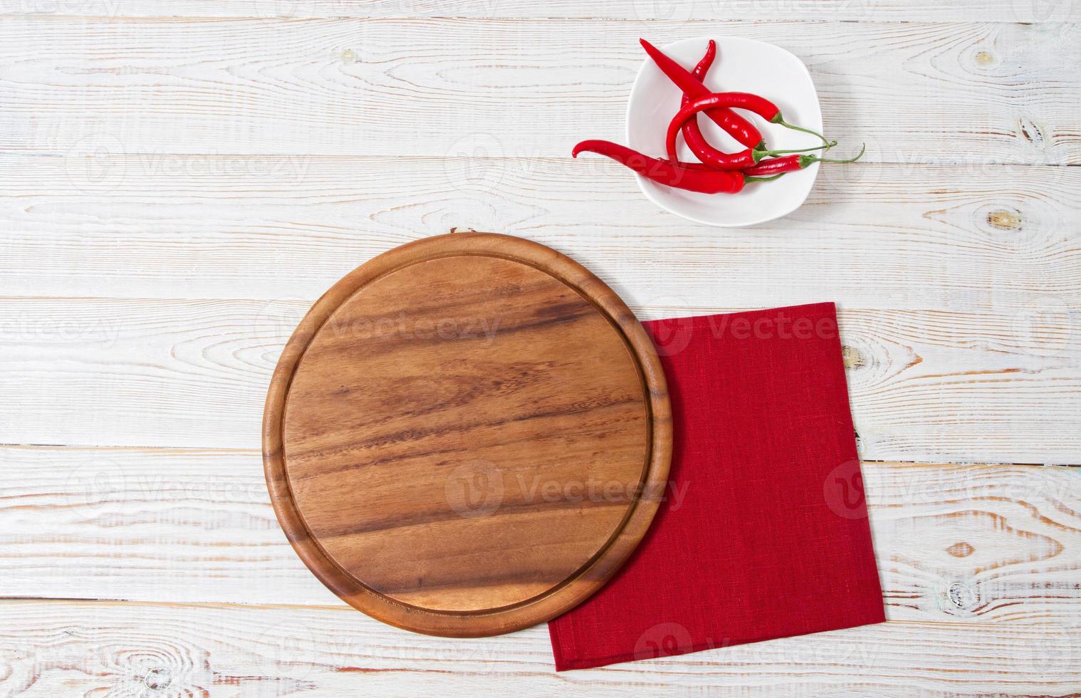 mesa de pizza vazia, chili peper e guardanapo vermelho na vista de cima da mesa de madeira foto