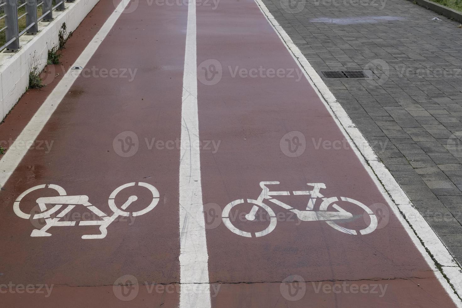 uma ciclovia com a imagem da bicicleta em ambas as direções, em uma cidade da Ligúria na riviera foto