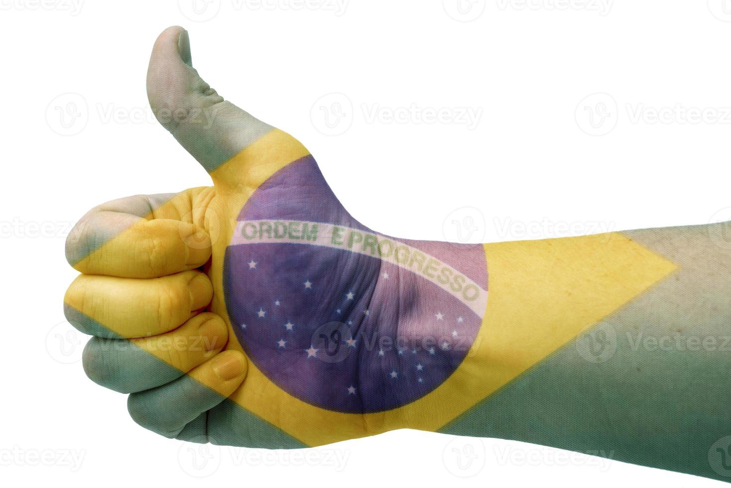 o conceito de brasil-a mão dá um polegar para cima com a bandeira do brasil. foto