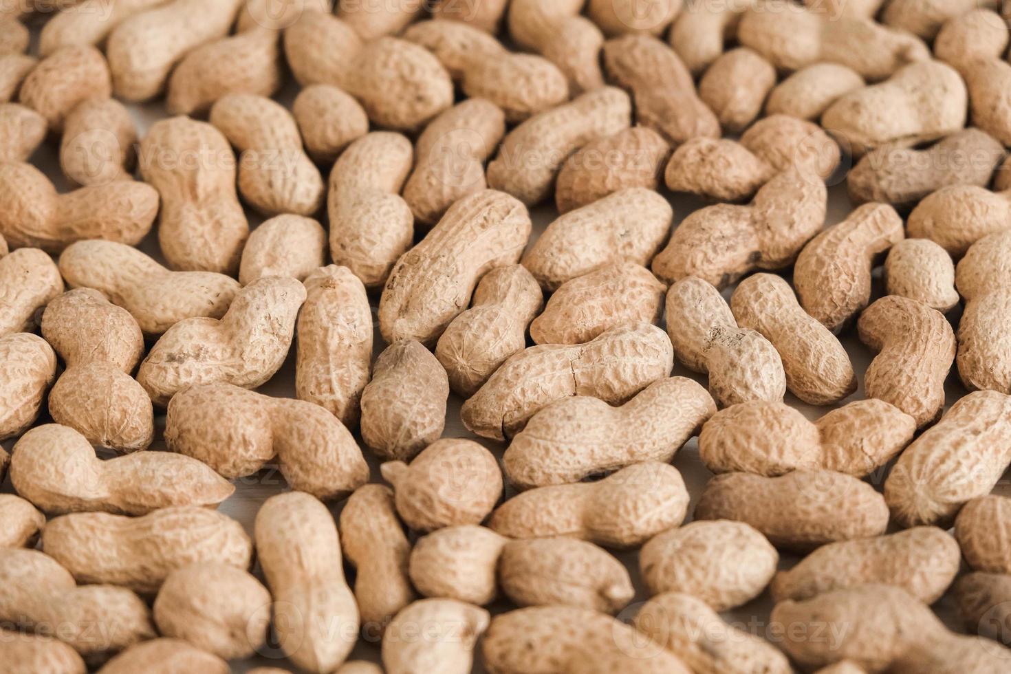 amendoins secos com casca como imagem de textura de fundo foto