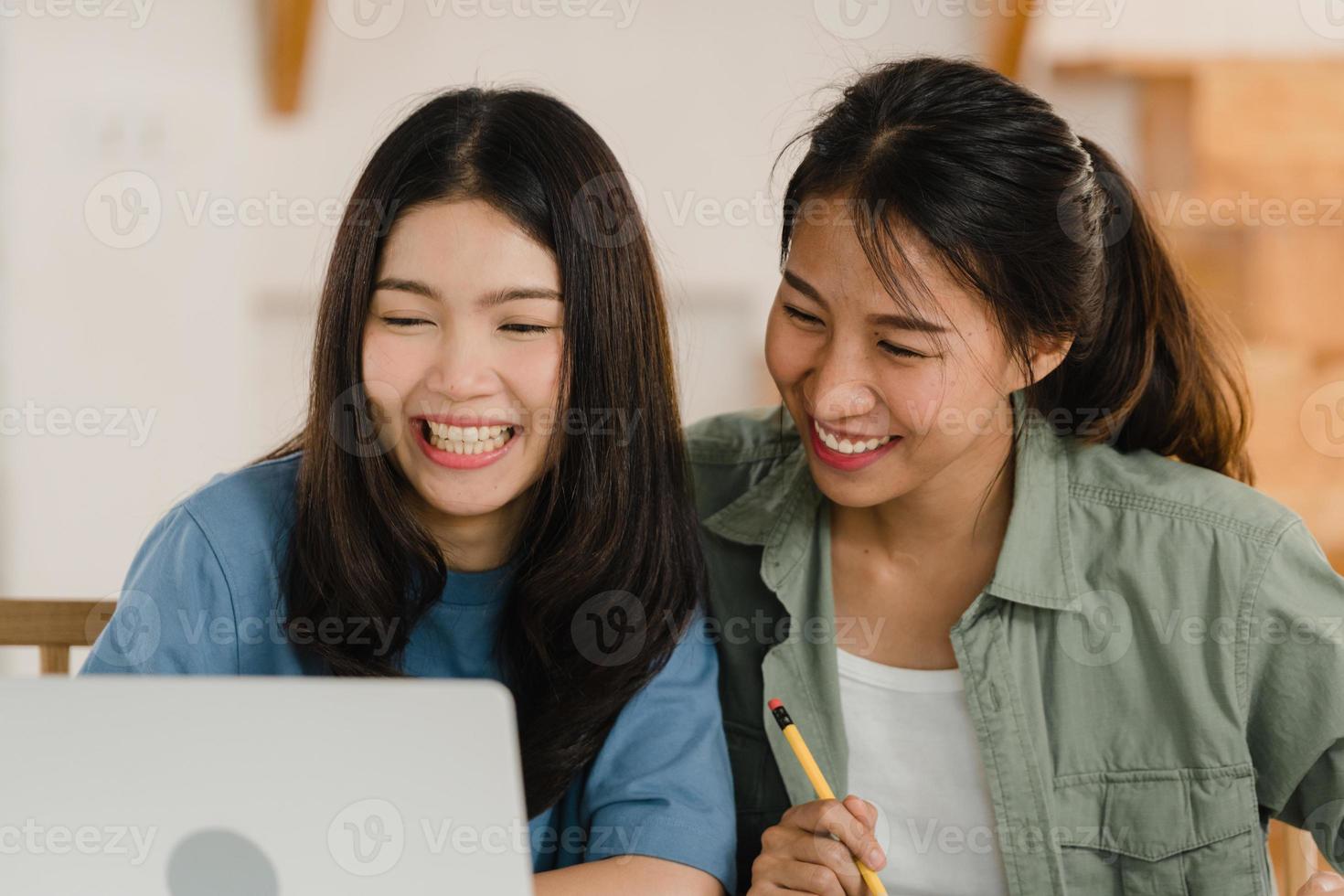casal de mulheres lésbicas lgbtq asiáticas de negócios fazem contas em casa, jovem garota asiática usando orçamento de registro de calculadora, imposto, documento financeiro no laptop trabalhando no conceito de cozinha. foto