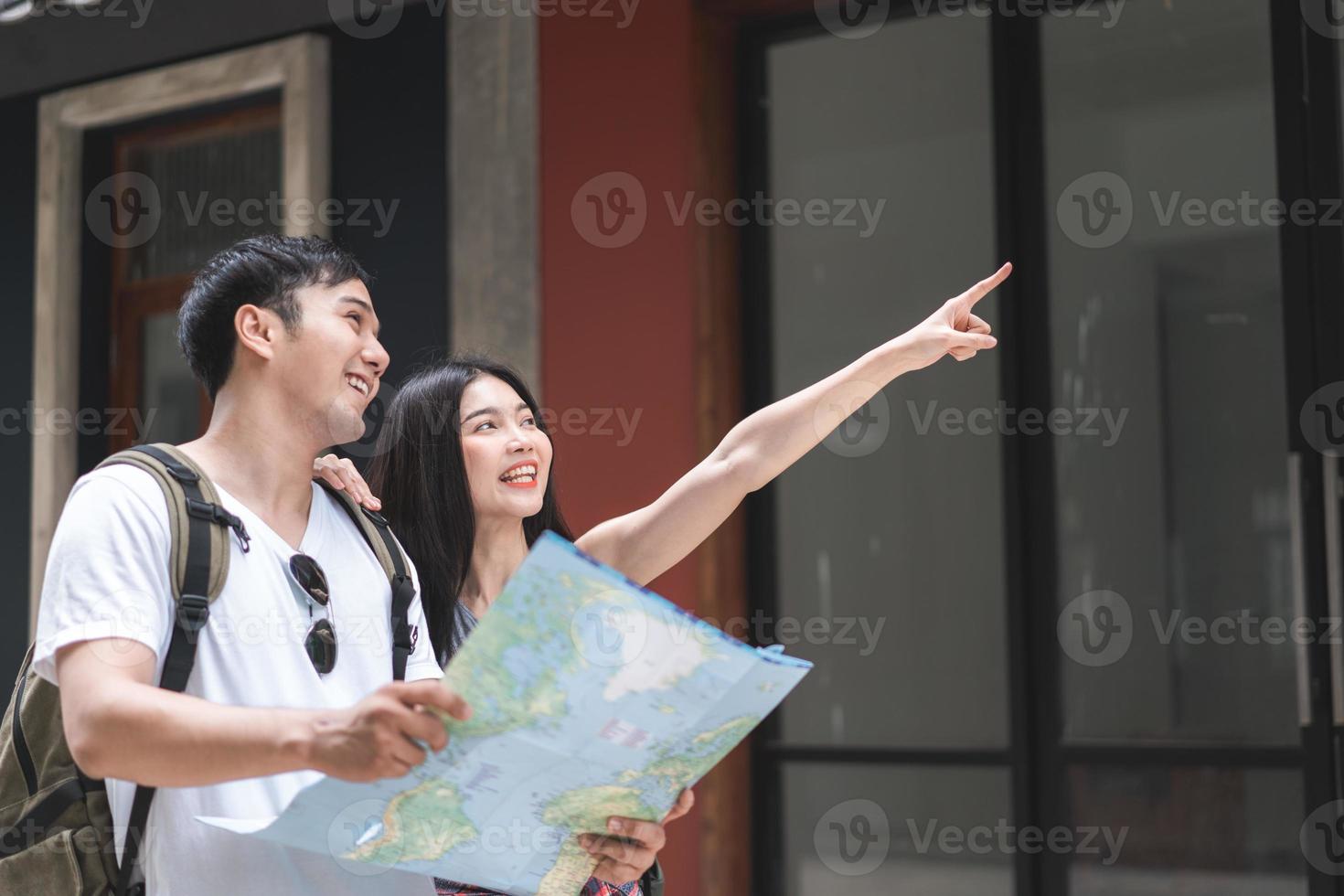 direção de casal asiático viajante no mapa de localização em pequim, china, doce casal asiático olhando no mapa encontrar marco enquanto passa a viagem de férias. casal de estilo de vida viaja no conceito de cidade. foto