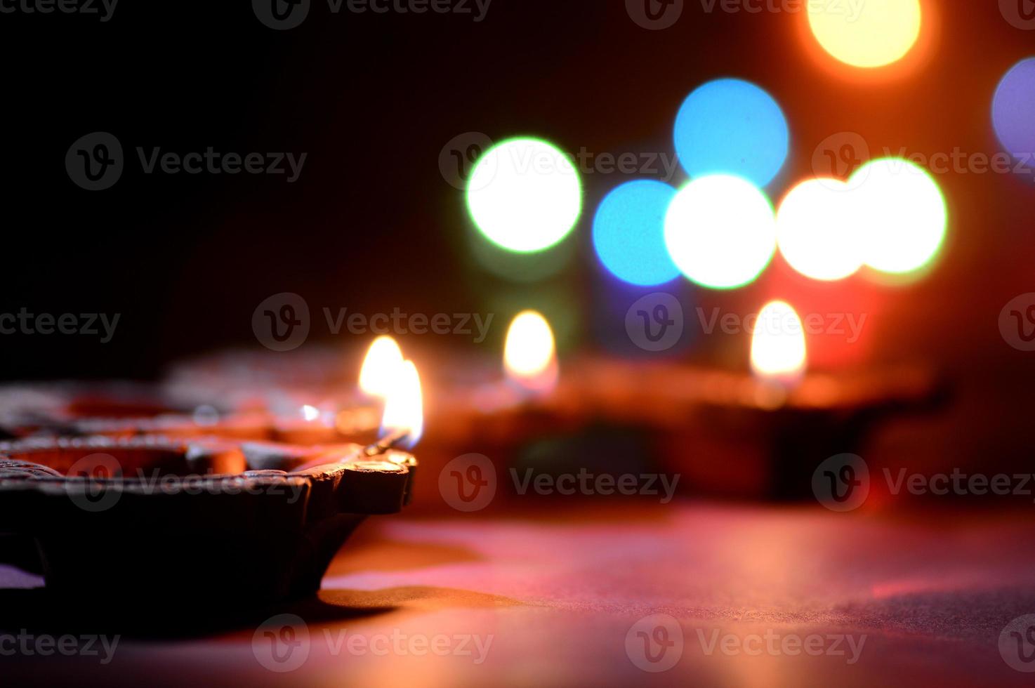 lâmpadas diya de argila acesas durante a celebração do diwali. projeto de cartão de saudações festival indiano da luz hindu chamado diwali foto