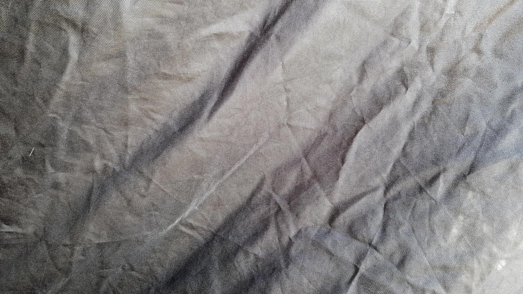 um fundo de textura de padrão de tecido de cor preta. fechar de bela textura de tecido preto enrugado. foto