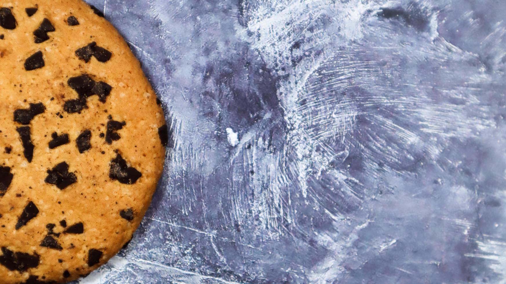 um biscoito de chocolate macio e recém-assado em uma bancada de cozinha de mármore cinza. pastelaria tradicional americana, sobremesa. deliciosa comida doce. postura plana. espaço de cópia foto