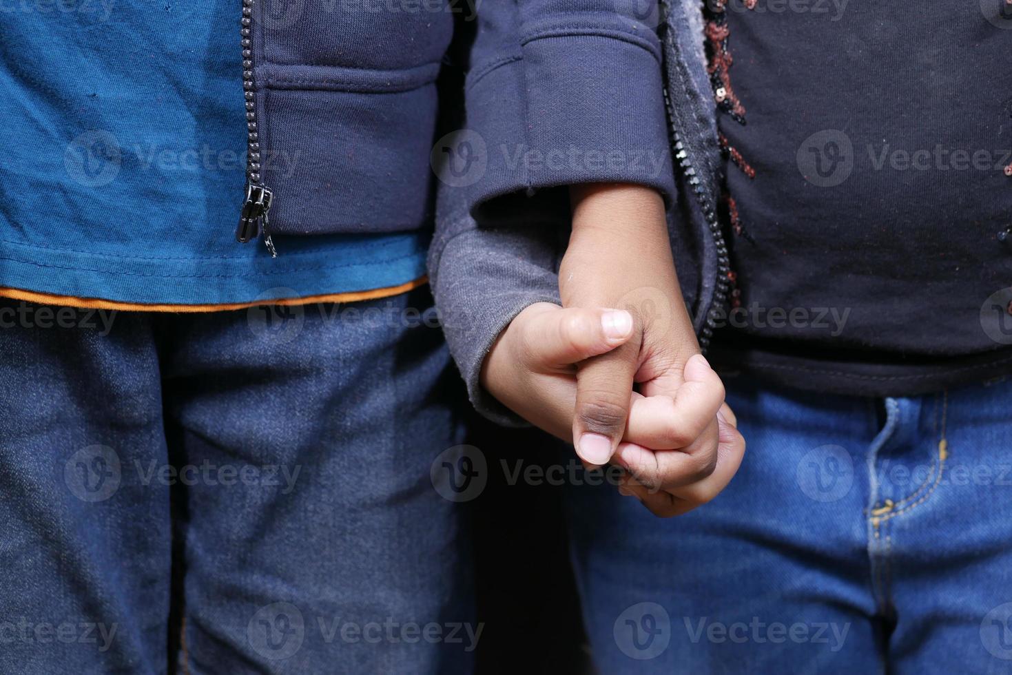 f criança menina segurando a mão de seu irmão foto