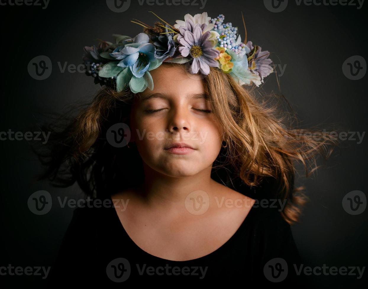 menina bonitinha com coroa de flores foto