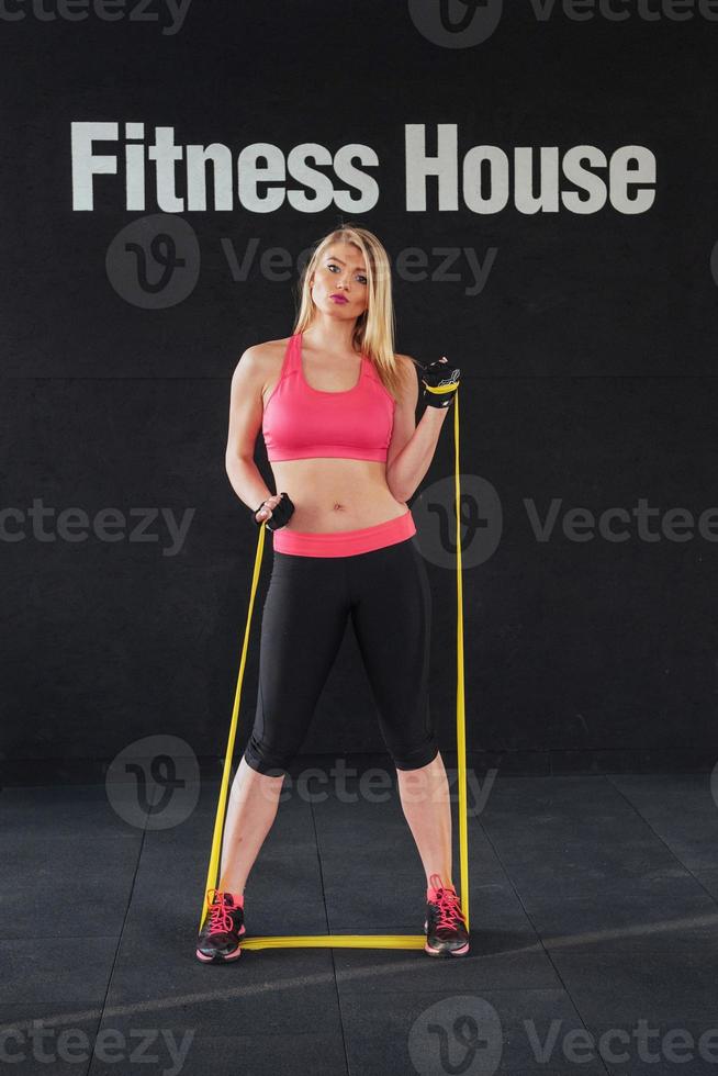 exercício de mulher em forma no estúdio de fitness com elásticos foto