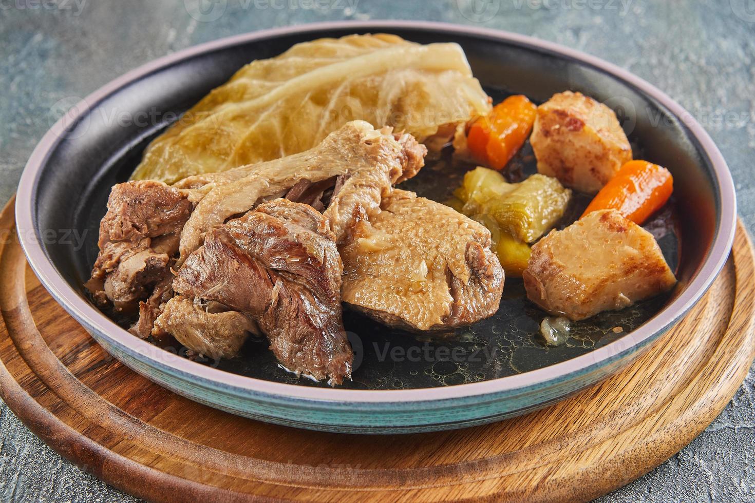 pot-au-feu de canard. um prato de inverno de pato com legumes foto