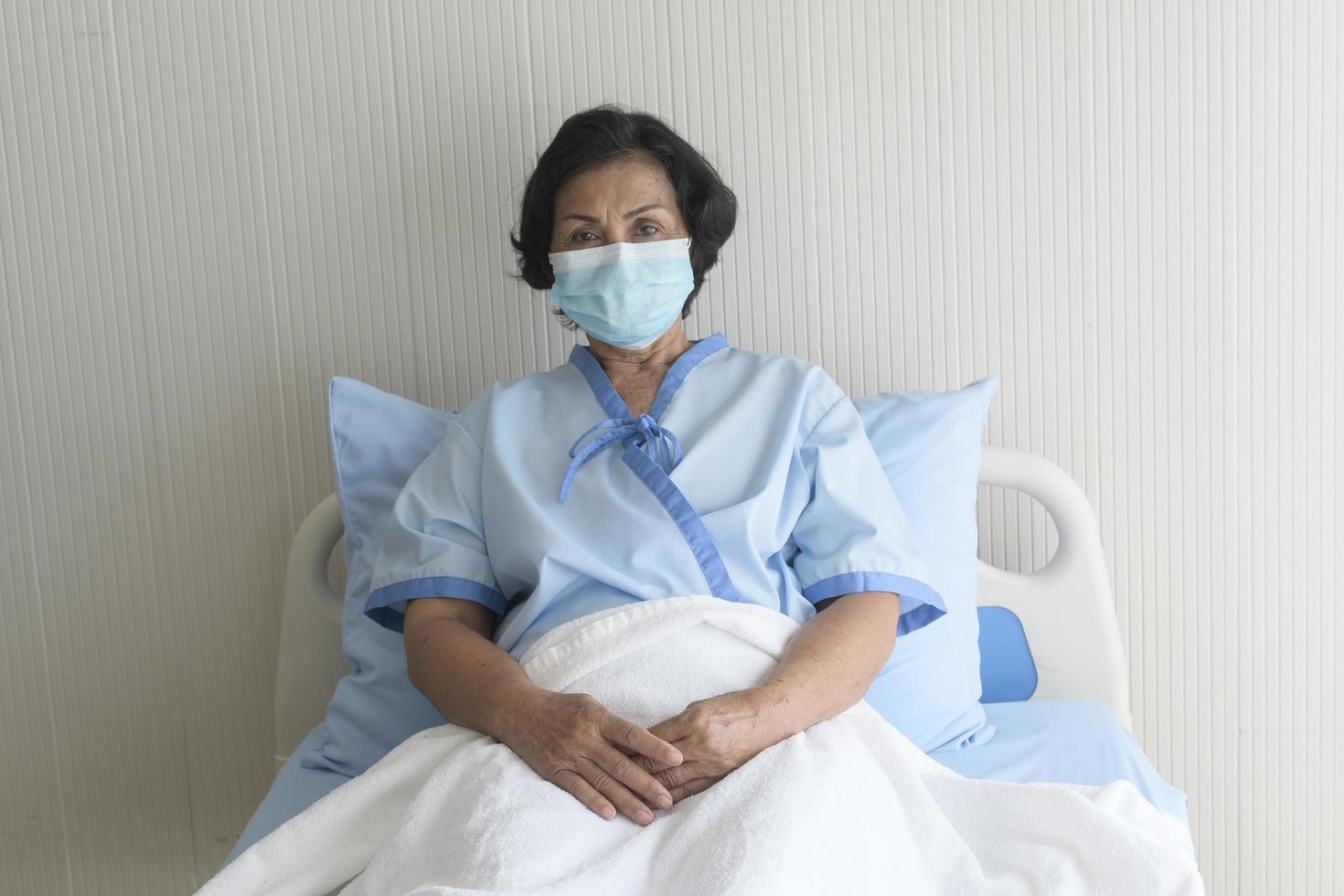 retrato de paciente sênior deitado na cama no hospital, cuidados de saúde e conceito médico foto