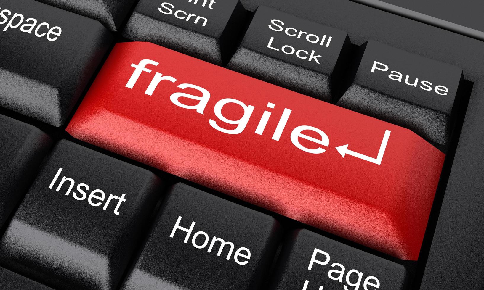 palavra frágil no botão vermelho do teclado foto