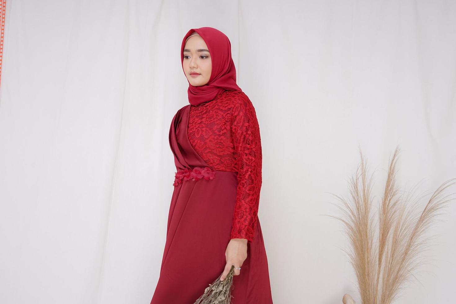 bela modelo feminino islâmico vestindo a moda hijab, uma roupa de estilo de vida moderno para a mulher muçulmana. conceito de vestido de noiva, beleza ou eidul fitri. uma modelo asiática usando hijab em uma sessão de fotos interna