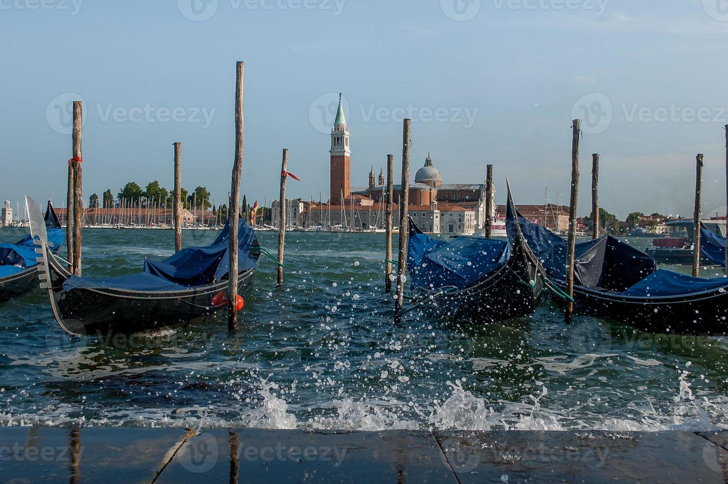 cliente de gôndolas à espera ancorado em veneza foto