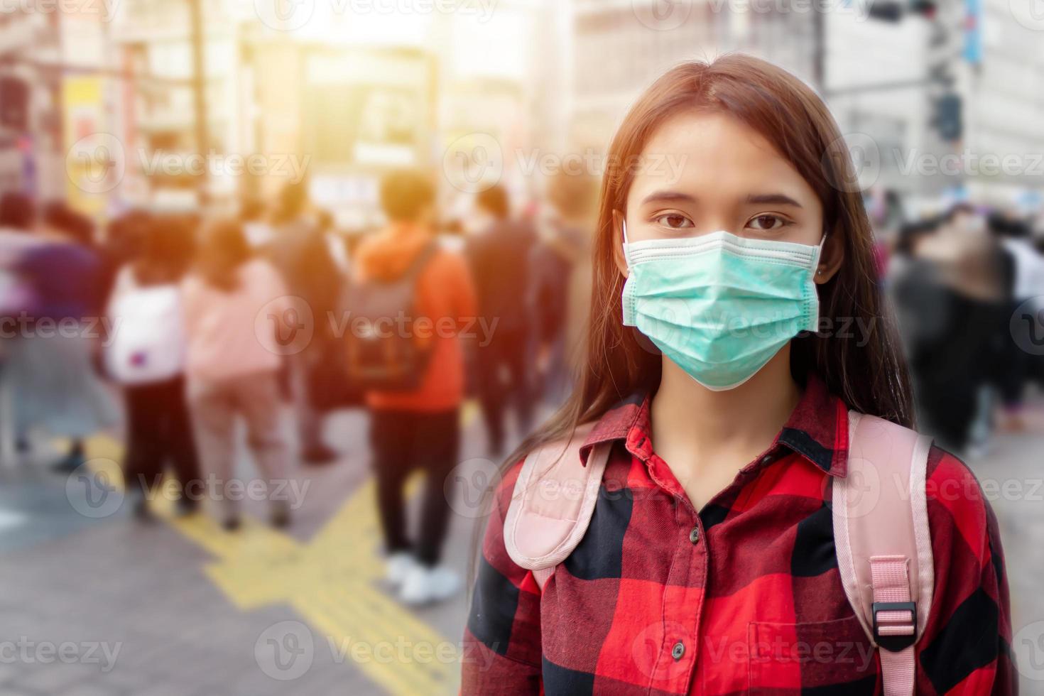 jovem asiática andando na cidade usando máscara de proteção no rosto por causa da poluição do ar, partículas e proteção contra vírus da gripe, influenza, coronavírus foto