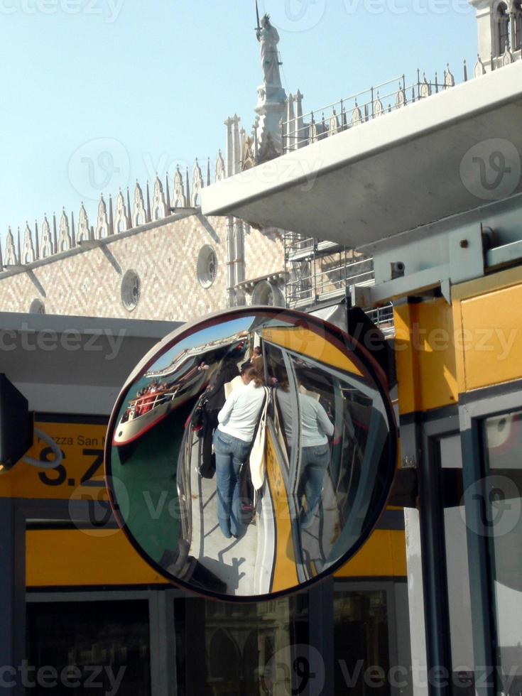 garota turista refletida no espelho em um barco na lagoa de veneza foto