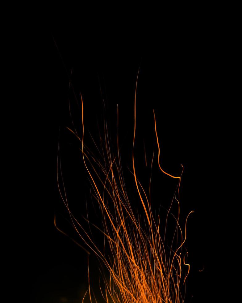 chamas de fogo com faíscas em um fundo preto foto