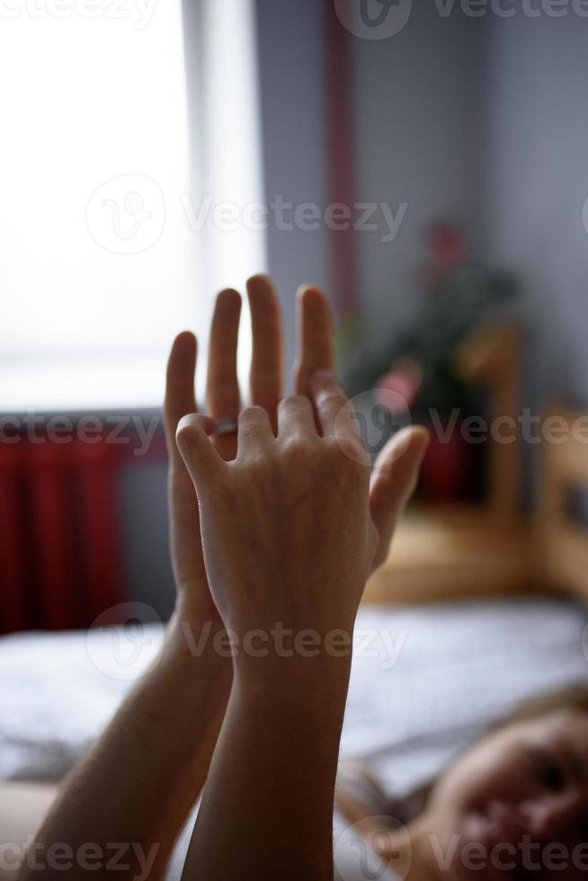 amoroso casal grávido segura as mãos um do outro para se apoiar durante o auto-isolamento. foto