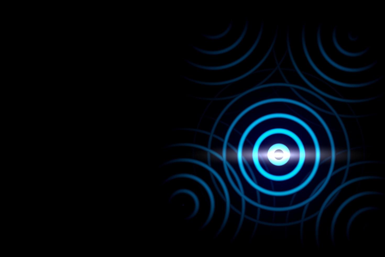 anel azul abstrato com turbilhão luminoso no pano de fundo preto. espiral brilhante com efeito de luz de círculos de luz. foto