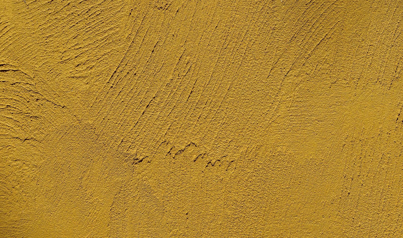 fundo de textura de parede de gesso amarelo mostarda foto