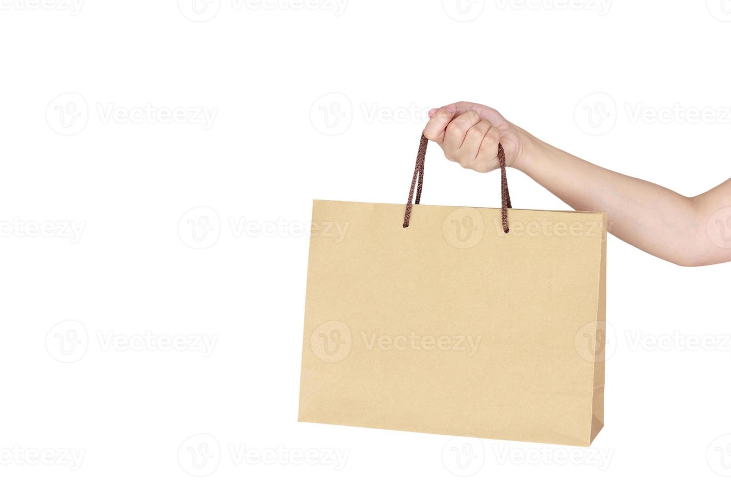 mão feminina segurando sacola de compras foto