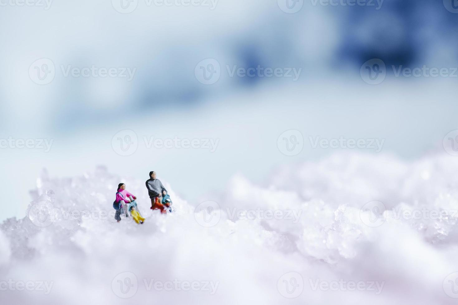 fundo de inverno com textura de neve e pessoas em miniatura foto