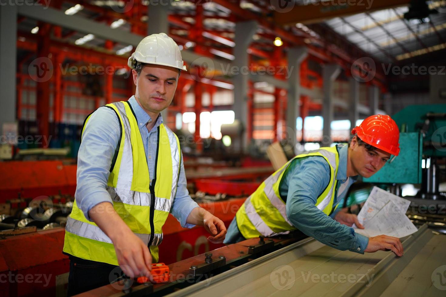 o capataz do trabalhador da indústria ou o trabalho do trabalhador no local da fábrica verificam a máquina ou os produtos no local. engenheiro ou técnico verificando material ou máquina na planta. industriais e fabris. foto