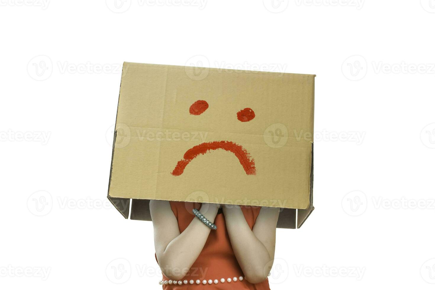 menina vestindo caixa de papelão na cabeça com cara de infeliz, isolado no fundo branco. foto