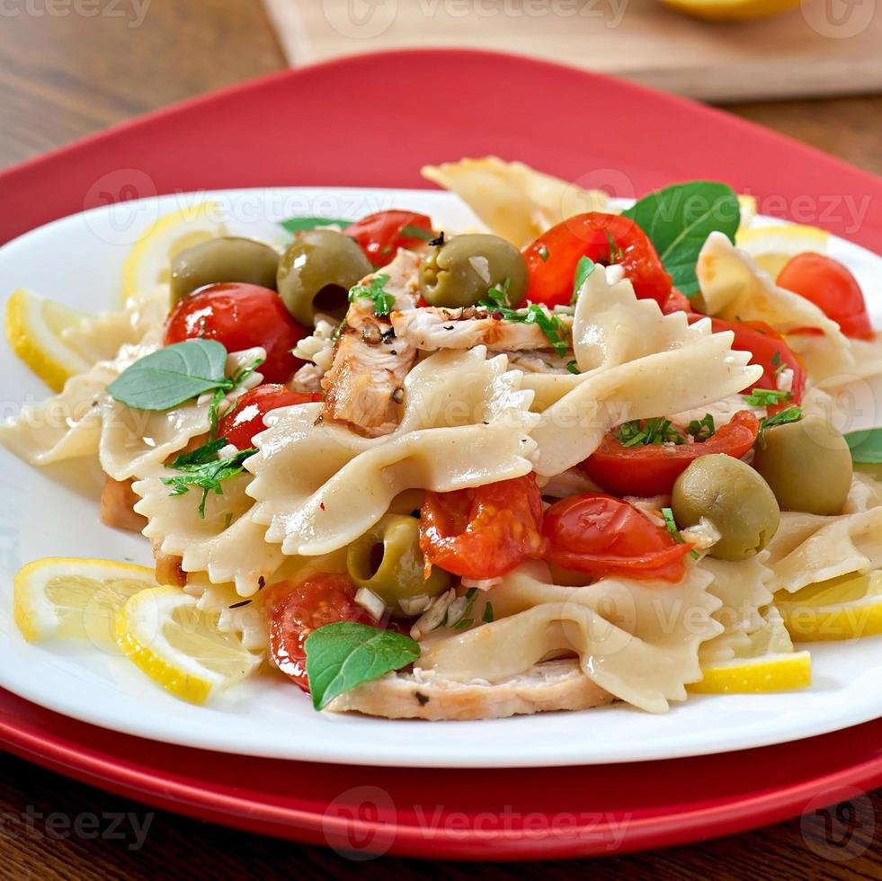 salada espanhola com laços de macarrão, tomate e frango foto