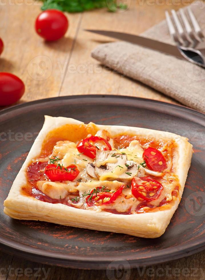 pizza com frango, tomate e cogumelos foto