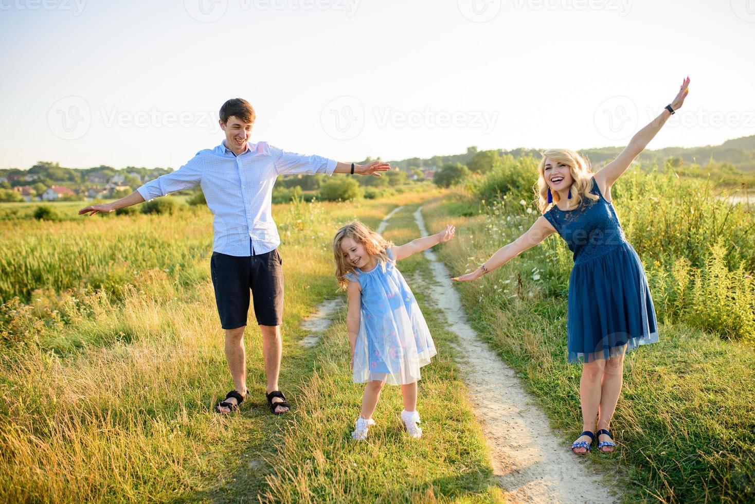 pai mãe e filha se divertem juntos na natureza. foto