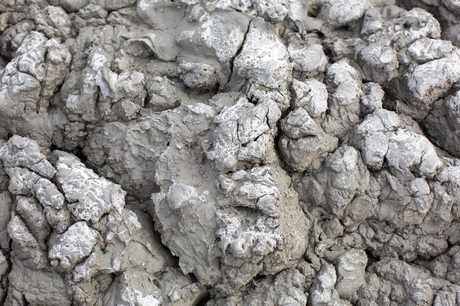 a textura da terra rachada cinza, argila vulcânica seca com rachaduras. cinza final. fundo natural, copyspace foto