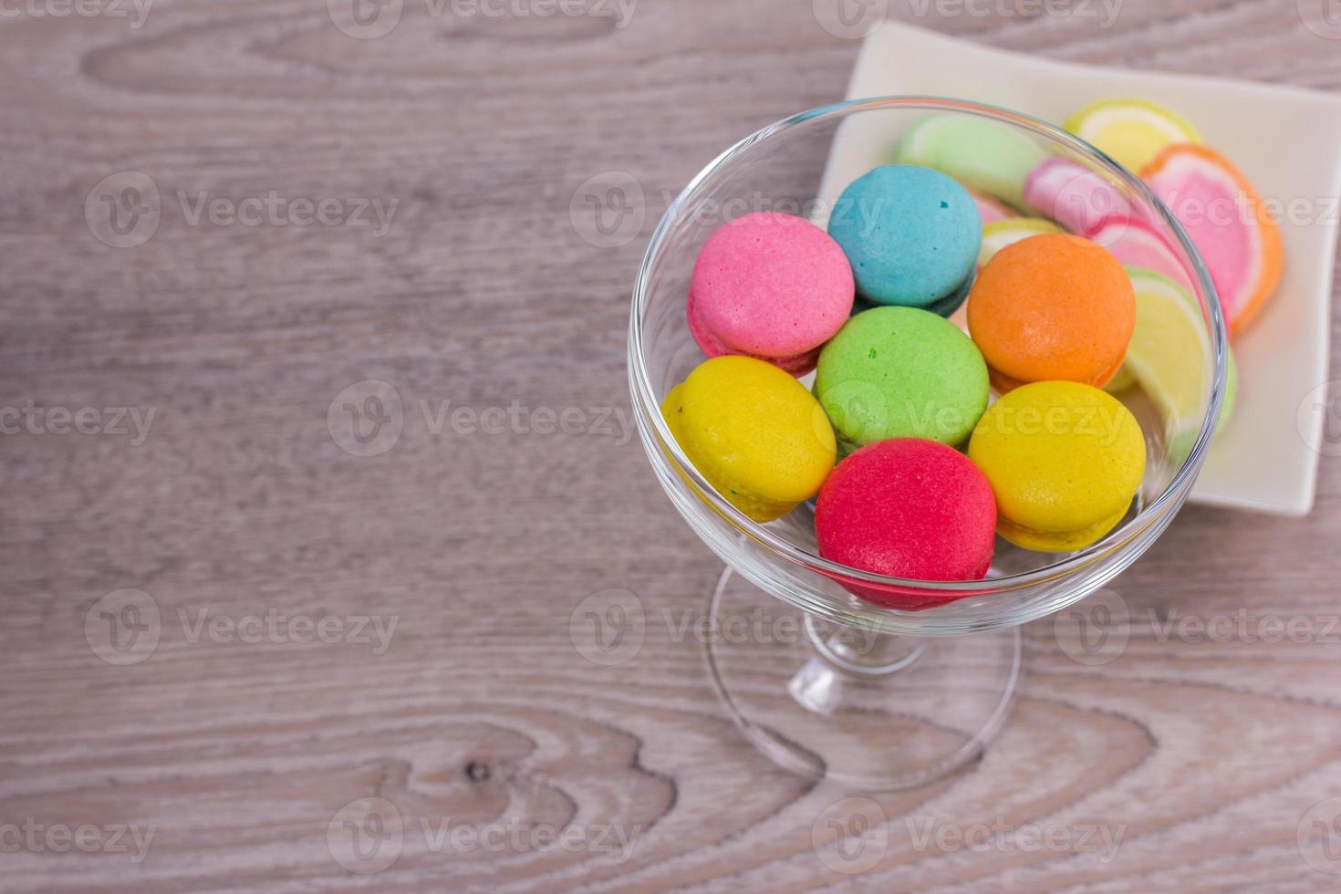 doces macaroons coloridos em um fundo de madeira foto