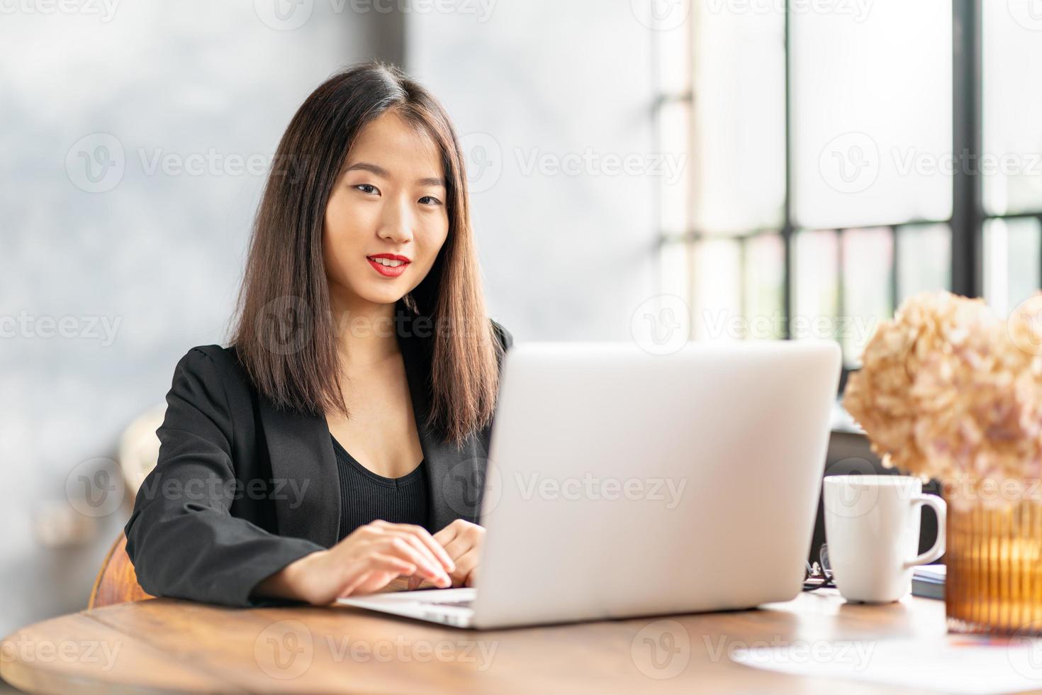 empresária japonesa trabalha no laptop no café. foto