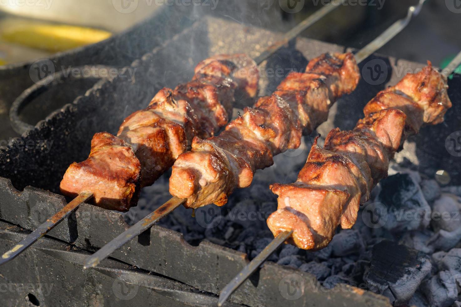 salsicha grelhada com adição de ervas e legumes na chapa de grelhar, ao ar livre. grelhar comida, churrasco, churrasco foto