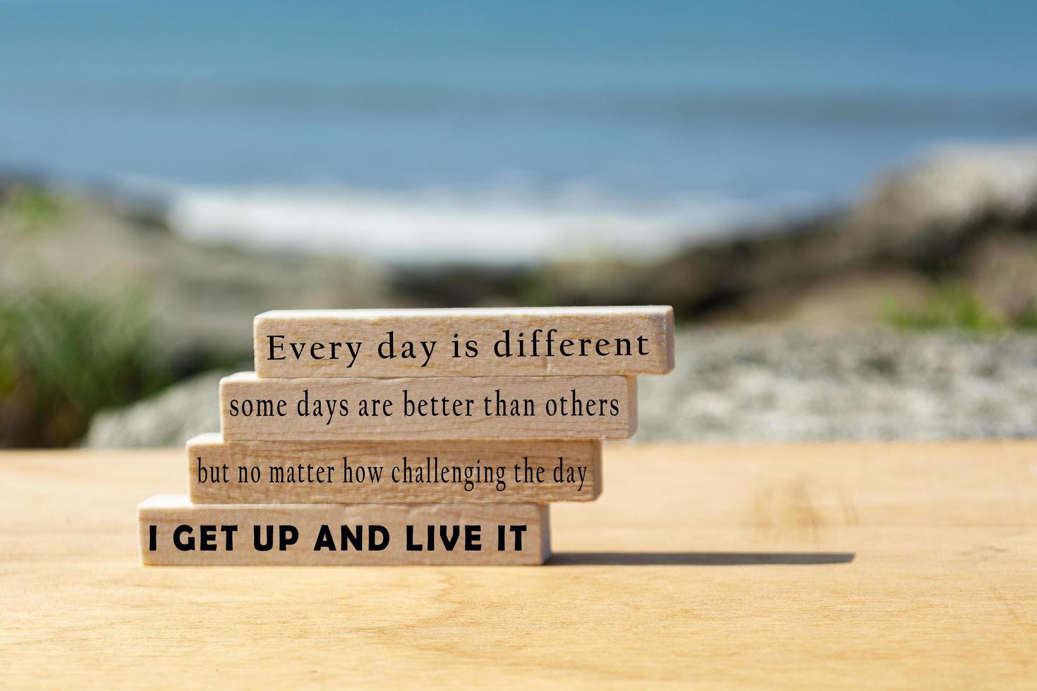 citação motivacional e inspiradora no bloco de madeira com fundo desfocado do oceano foto