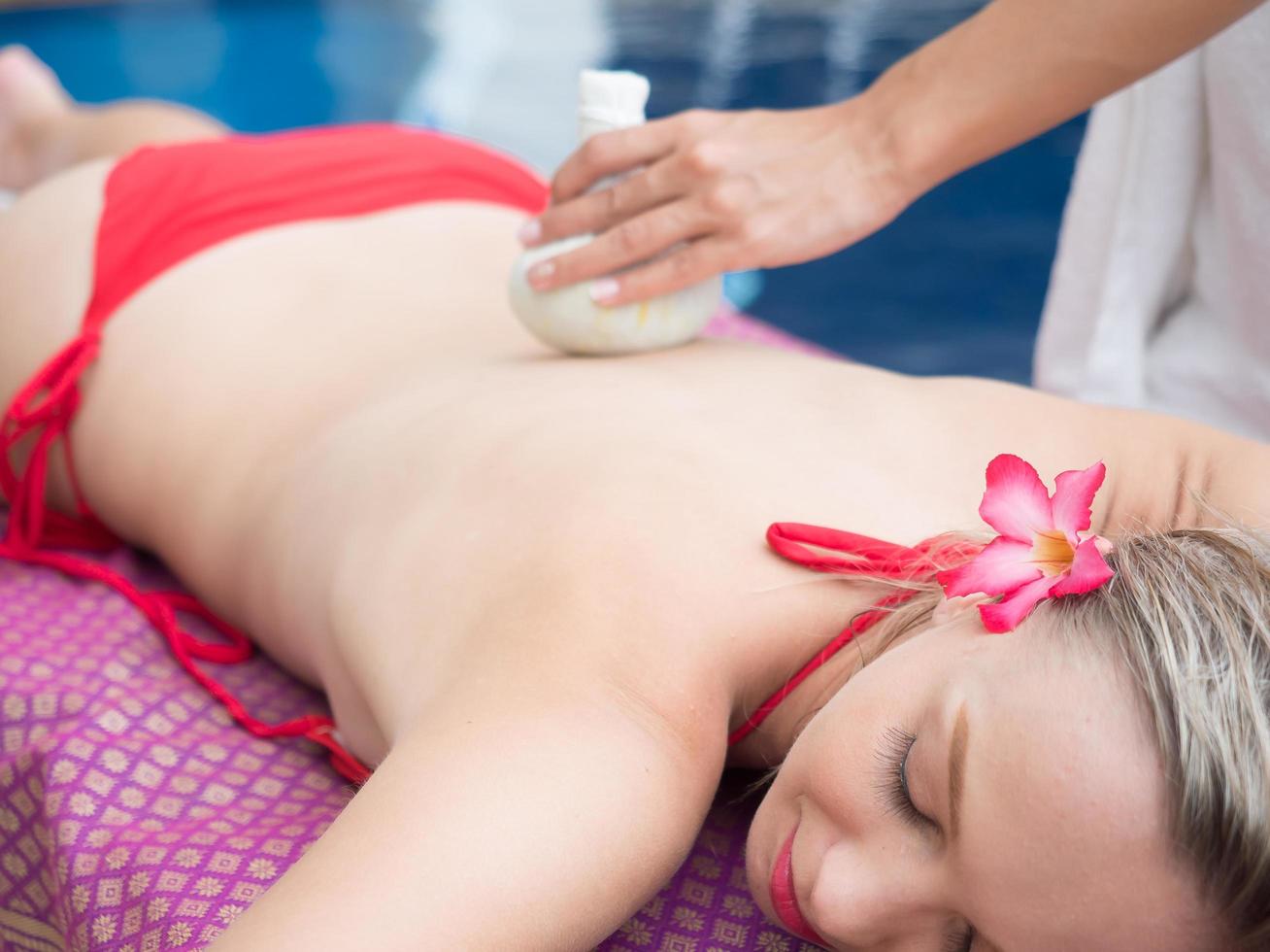 linda garota relaxar spa e massagem terapêutica ao lado da piscina foto