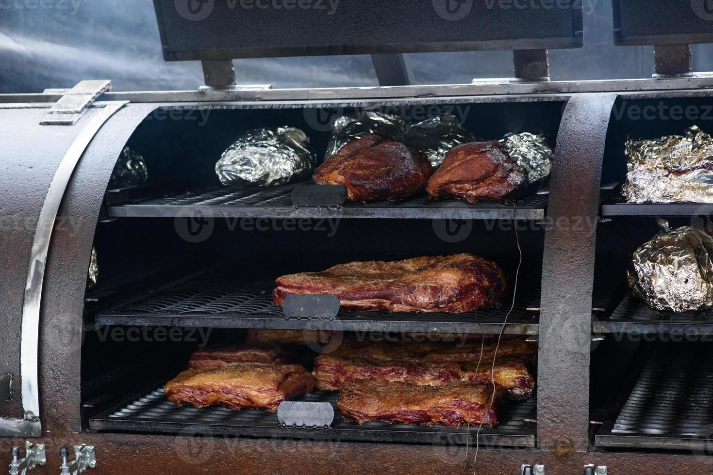 espetos de carne grelhados na brasa, com fumaça. comida de rua. foto