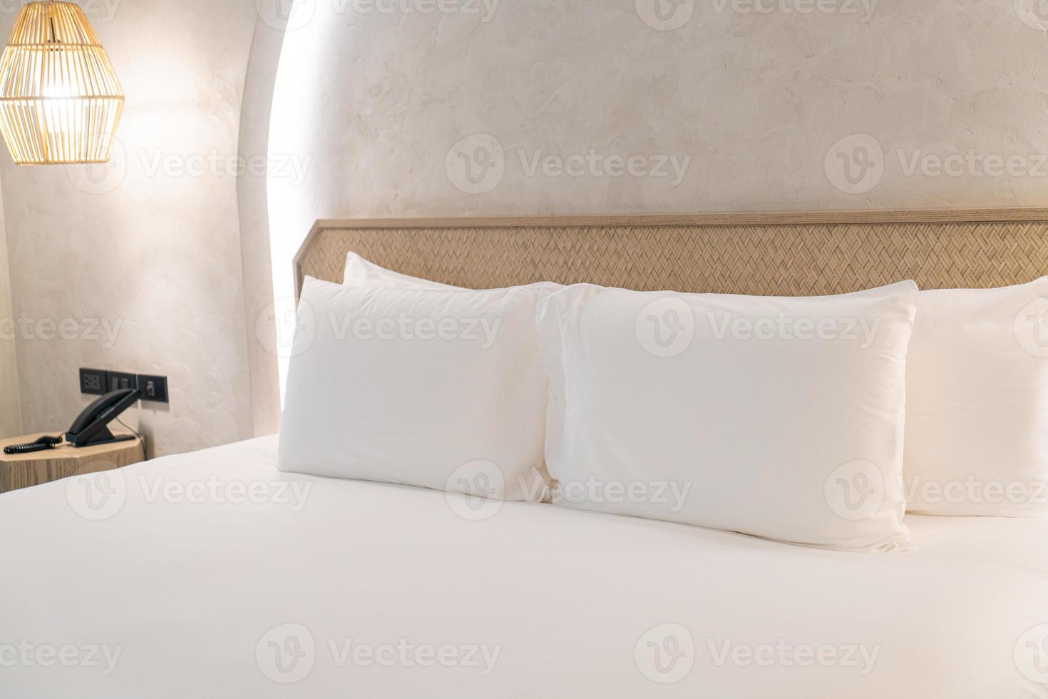 travesseiros brancos confortáveis na cama foto