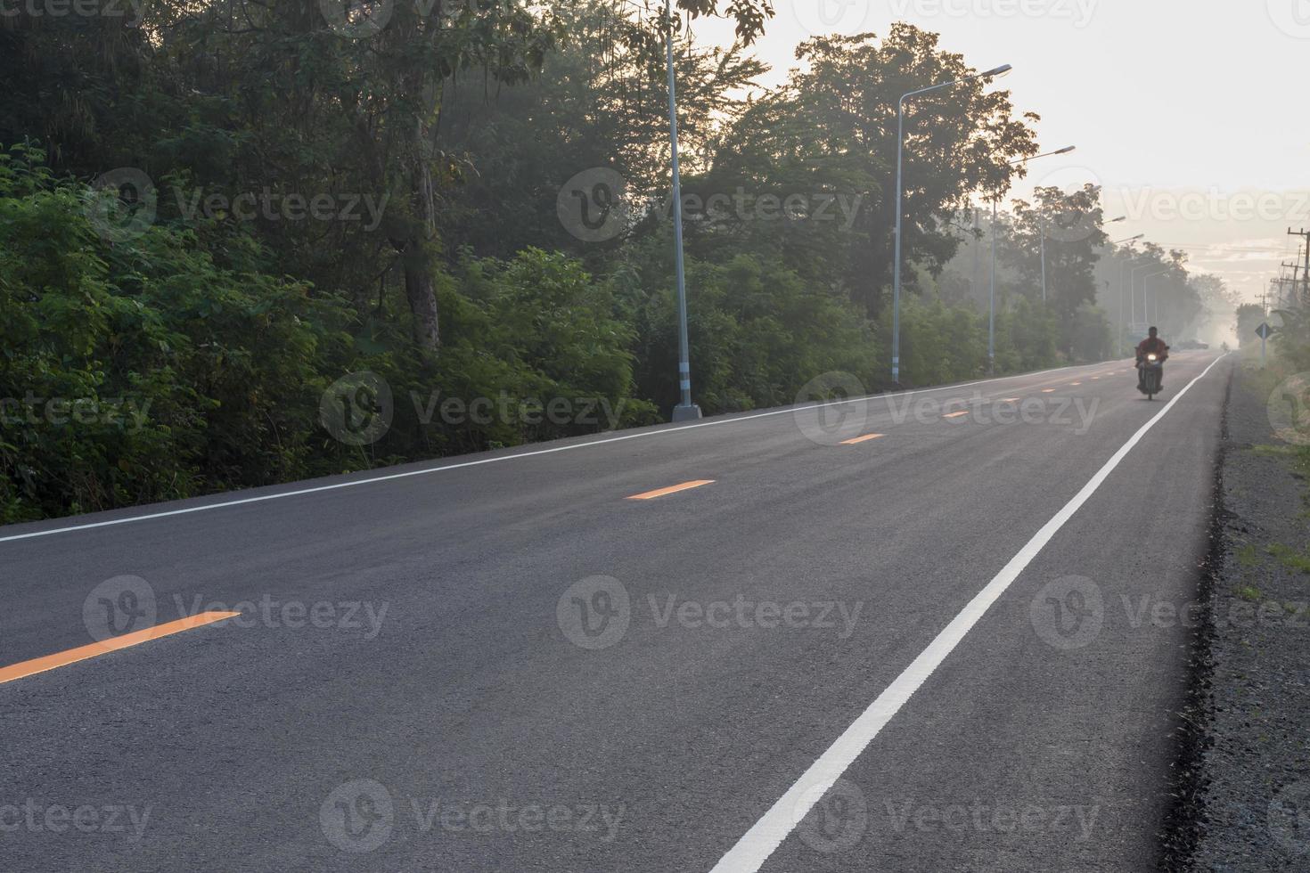 estrada de asfalto com sol nascendo na zona rural. foto