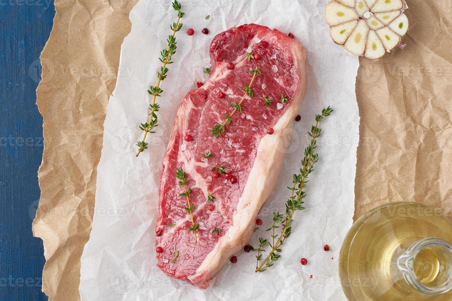 grande pedaço inteiro de carne de bovino crua, contrafilé em papel manteiga branco foto