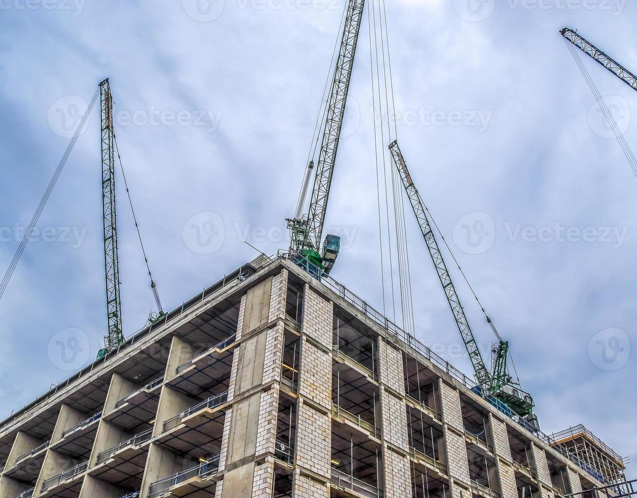 vários guindastes em canteiros de obras em edifícios altos em toda a europa foto